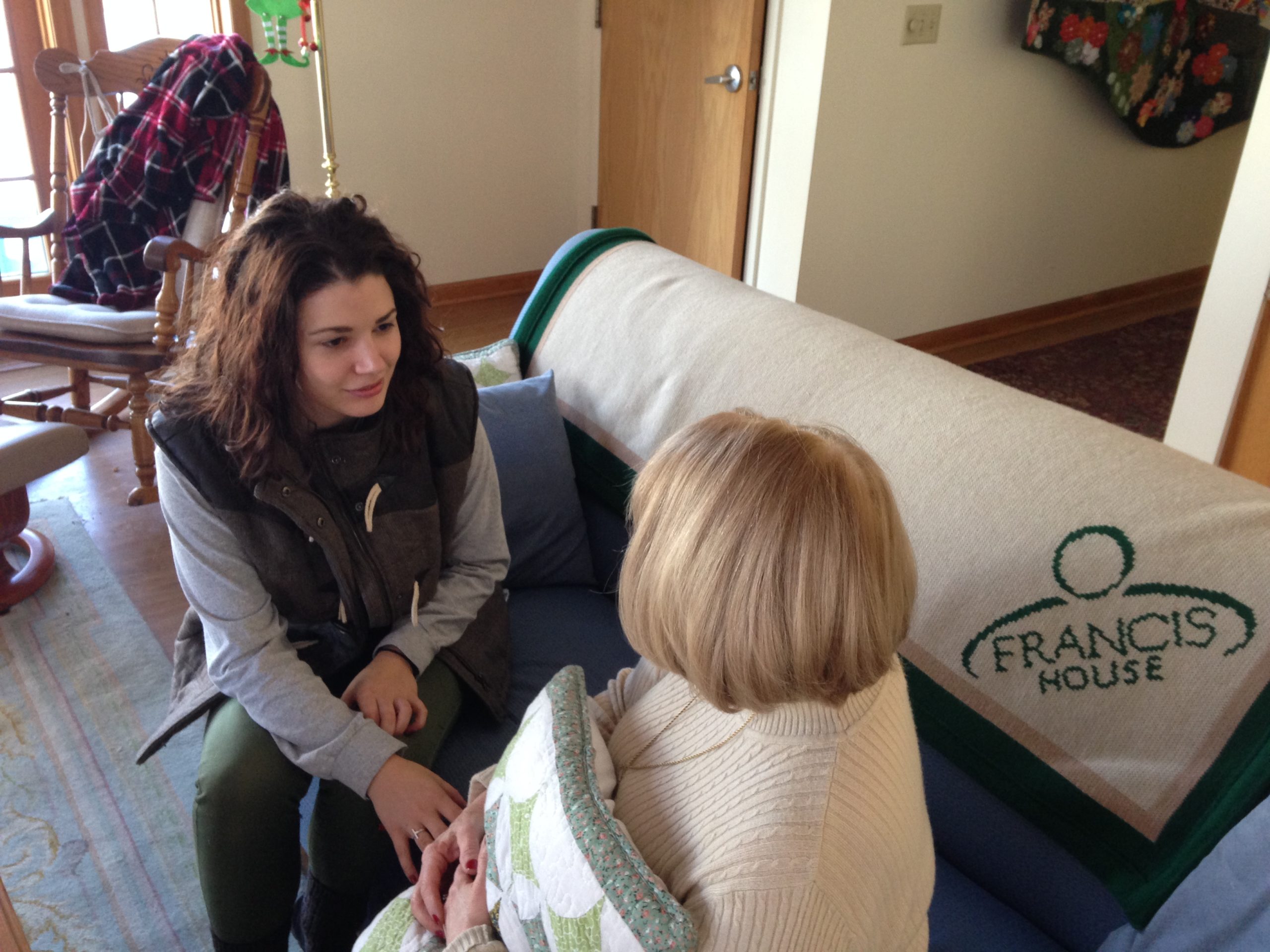 FrancisCorps volunteer talking with a Francis House resident